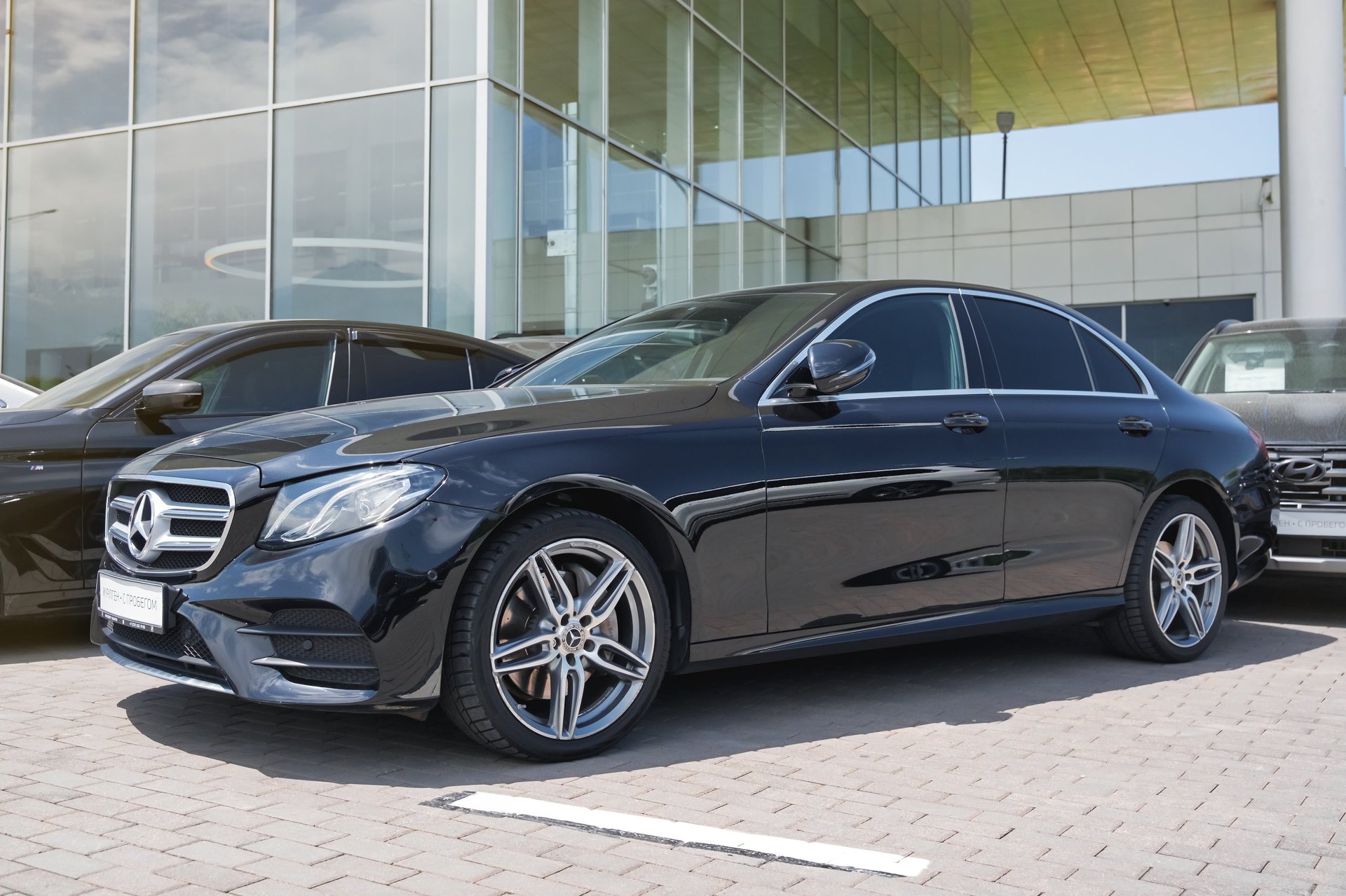 Black Mercedes-Benz E-Class executive vehicle in urban setting