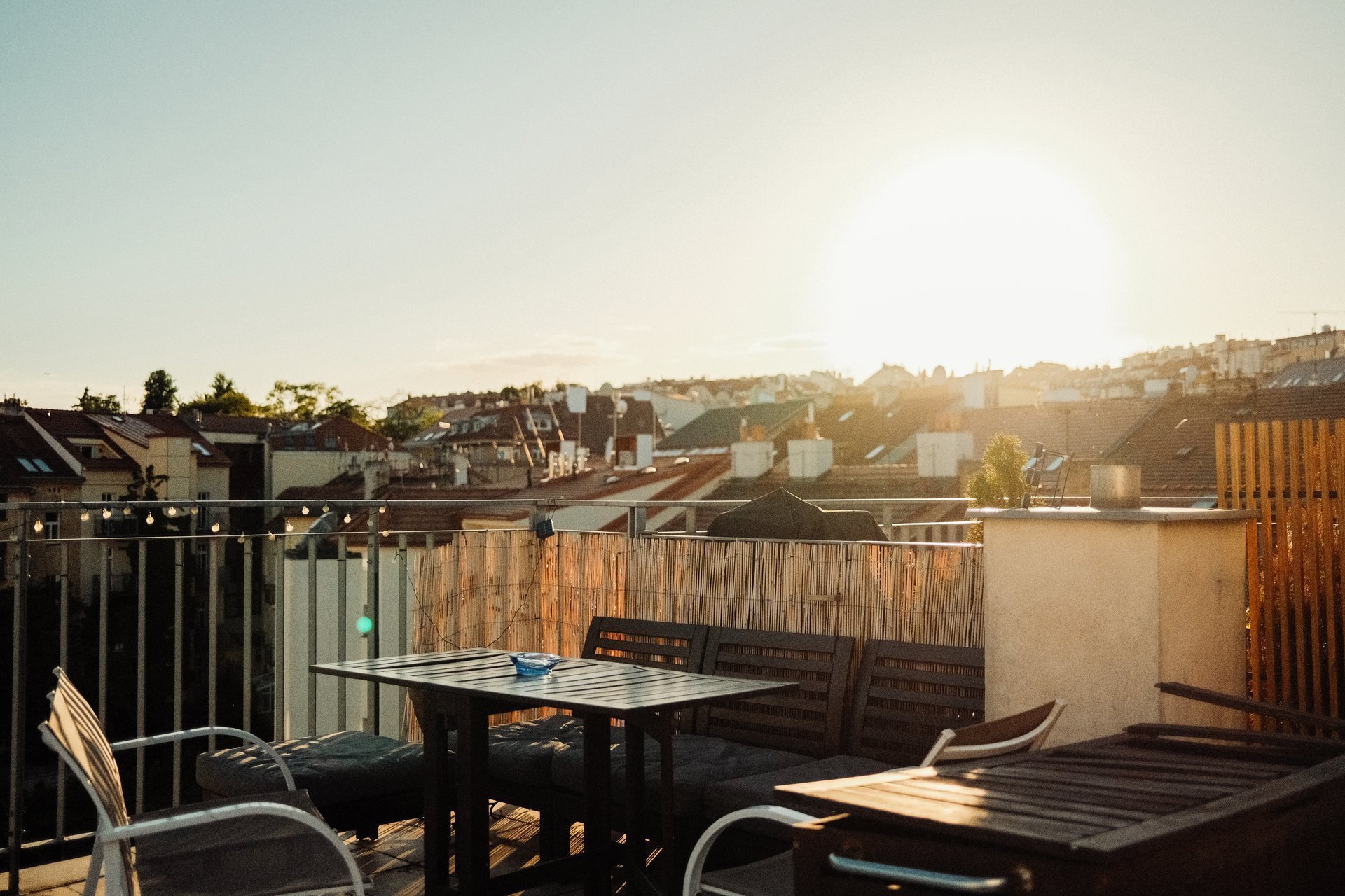 European city rooftop terrace at golden hour with historic architecture