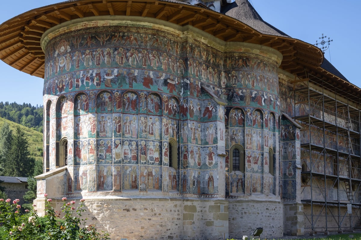 Detailed view of the painted exterior murals on the walls of Sucevița Monastery in Romania.