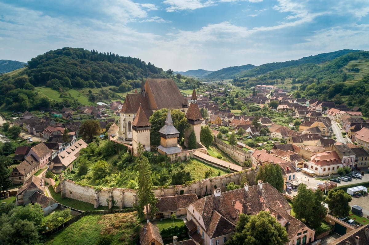Aerial view of the fortified Saxon church of Biertan, a UNESCO World Heritage site, surrounded by the village houses and landscape of Biertan village, Transylvania, Romania