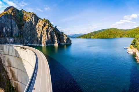 Dam gates releasing water in mountain landscape