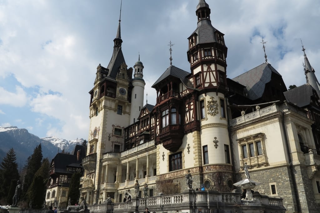 Neuschwanstein Castle, a large ornate Romanesque Revival castle with multiple towers and turrets set against a mountainous backdrop